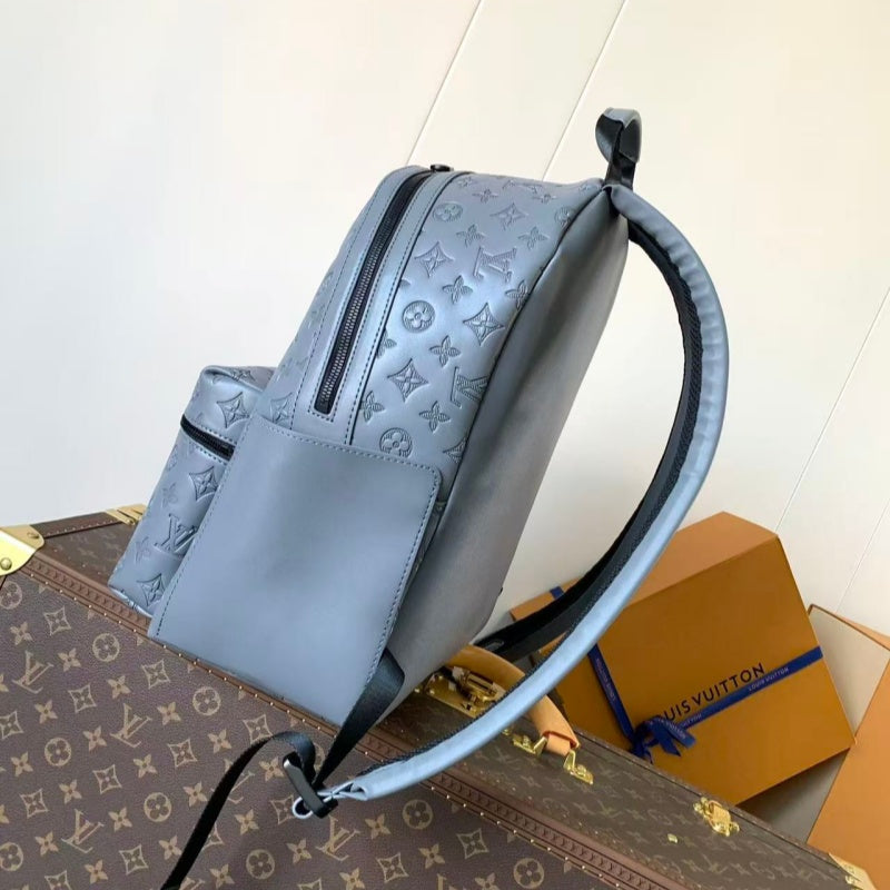 Grey embossed cowhide backpack, featuring metal hardware that exudes a refined, understated air.