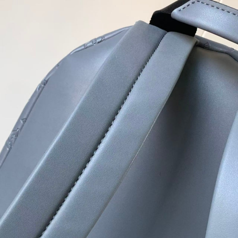 Grey embossed cowhide backpack, featuring metal hardware that exudes a refined, understated air.
