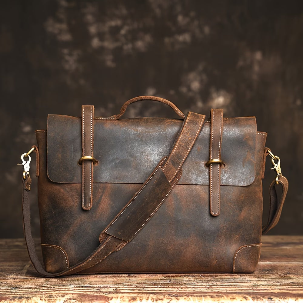 Briefcase/messenger bag in top-grain cowhide with a vintage style; features a shoulder strap suitable for crossbody wear.