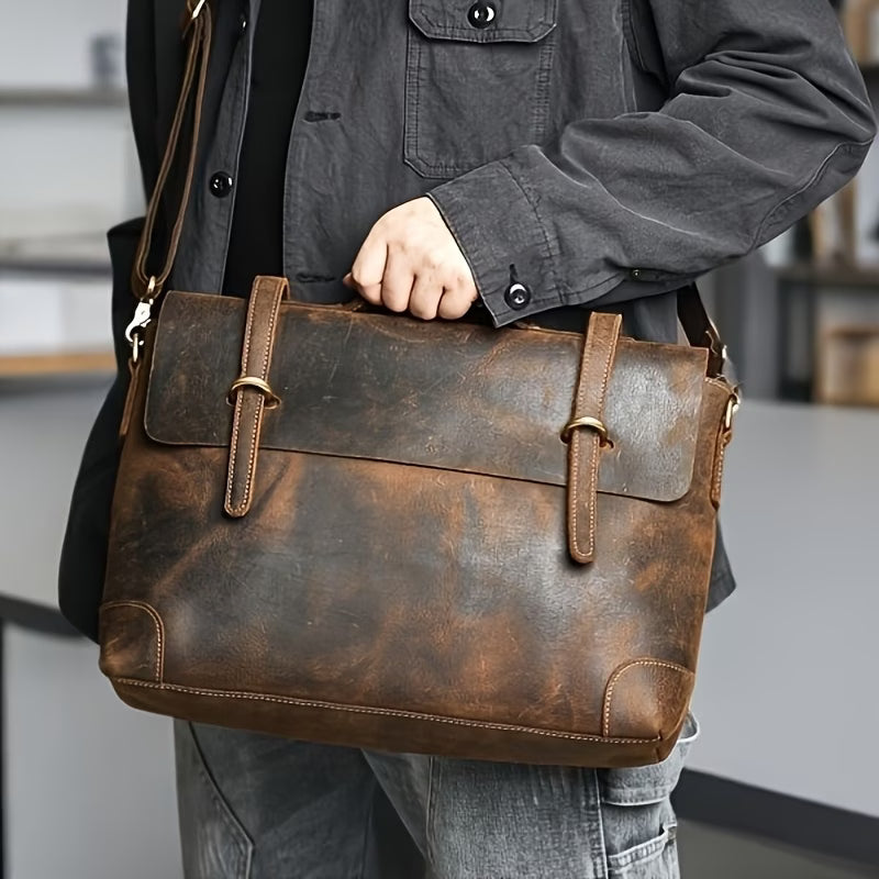 Briefcase/messenger bag in top-grain cowhide with a vintage style; features a shoulder strap suitable for crossbody wear.