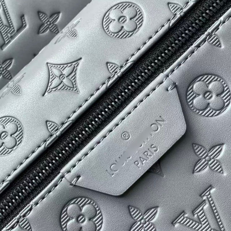 Grey embossed cowhide backpack, featuring metal hardware that exudes a refined, understated air.
