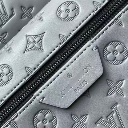 Grey embossed cowhide backpack, featuring metal hardware that exudes a refined, understated air.