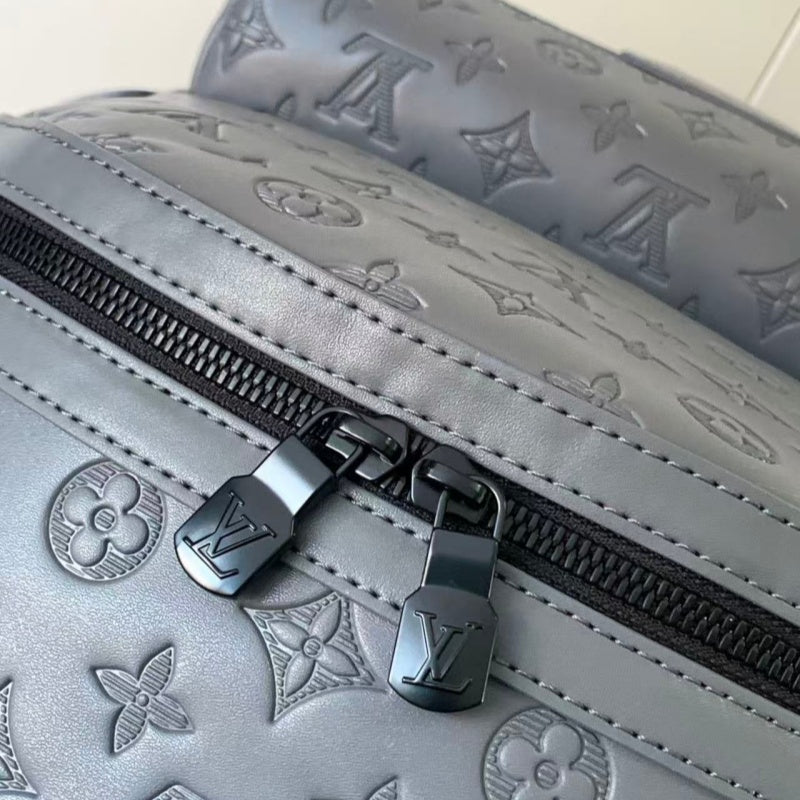 Grey embossed cowhide backpack, featuring metal hardware that exudes a refined, understated air.