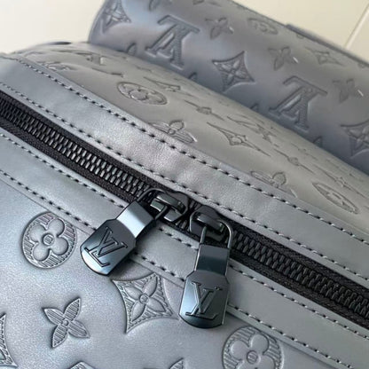 Grey embossed cowhide backpack, featuring metal hardware that exudes a refined, understated air.