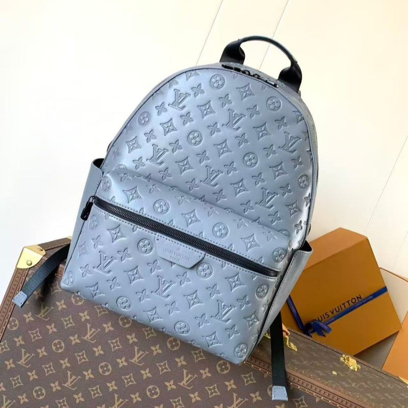 Grey embossed cowhide backpack, featuring metal hardware that exudes a refined, understated air.