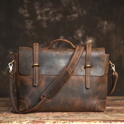 Briefcase/messenger bag in top-grain cowhide with a vintage style; features a shoulder strap suitable for crossbody wear.