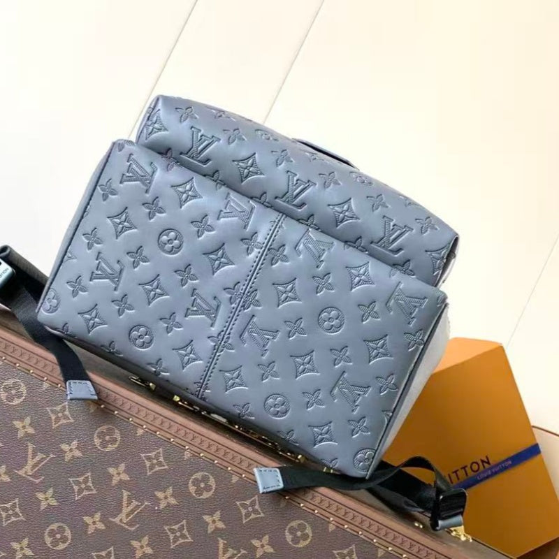Grey embossed cowhide backpack, featuring metal hardware that exudes a refined, understated air.